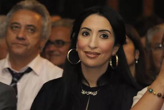 Salwa Idrissi Akhannouch seated among guests at a public event.