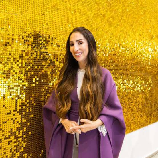 A retail brand launch environment with a gold sequin feature wall.