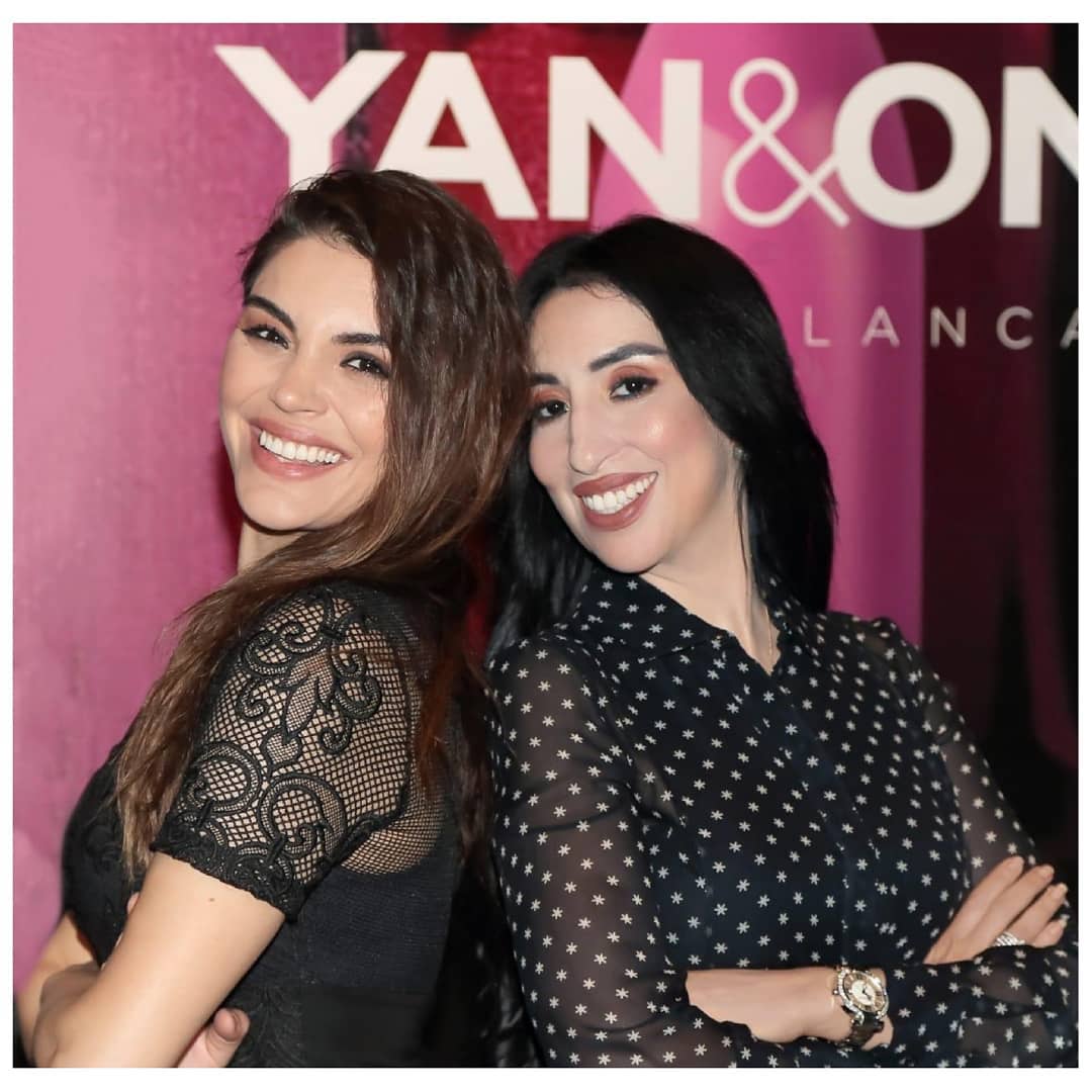 Guests at a Yan&One brand event in Casablanca, photographed in front of the brand backdrop.